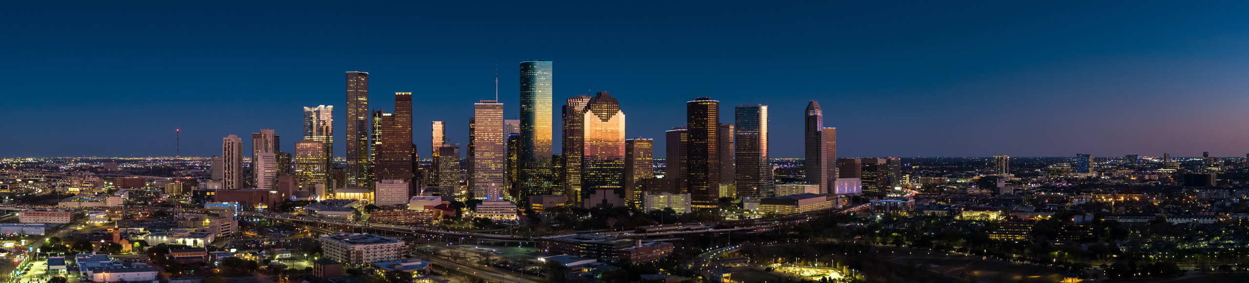 Twilight skyline image of downtown Houston, TX. Greater Houston is a service area of MOVES Mobile Veterinary Specialists.